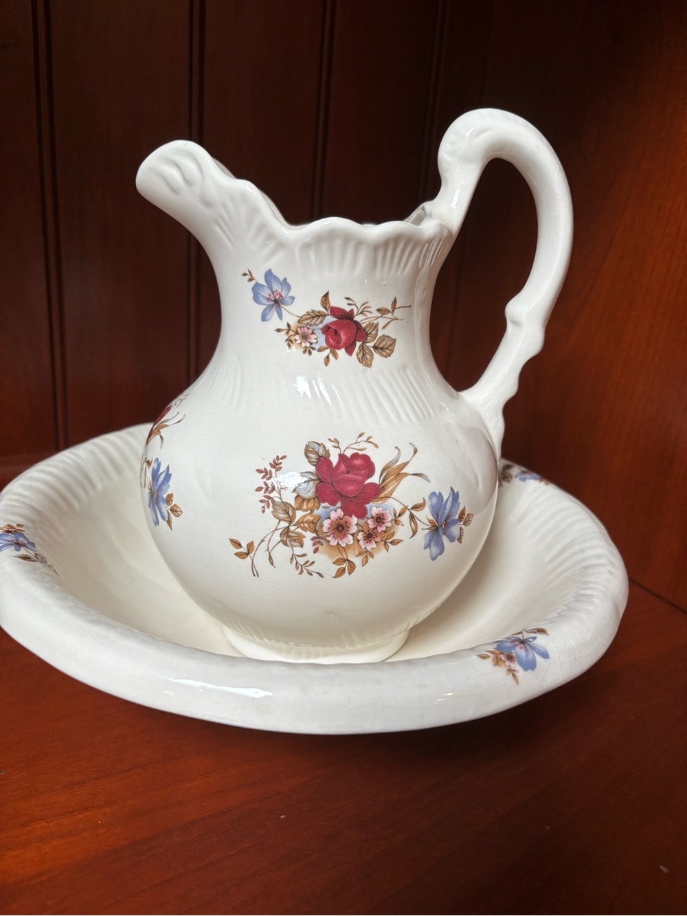 Vintage ceramic wash basin and pitcher set showcases a timeless cream base